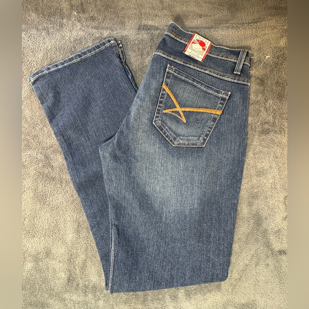 Cinch Women's Boot Cut Jeans in Classic Blue with kick slit